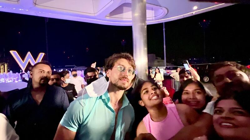 Tiger Shroff, who will perform at the IIFA Awards, takes selfies with fans.