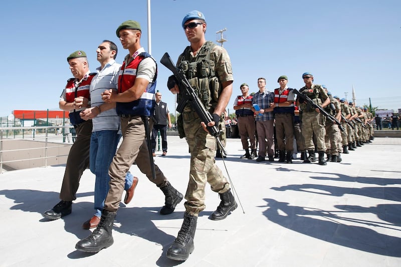 epa06119621 Arrested soldiers who participated in the 2016 attempted coup d'etat in Turkey, are accompany by Turkish soldiers as they arrive at the court inside of the Sincan Prison before trial in Ankara, Turkey, 01 August 2017. Three-hundred-thirty soldiers who allegedly plotted the failed 15 July 2016 coup d'etat in Turkey went on trial on 01 August 2017.  EPA/TUMAY BERKIN