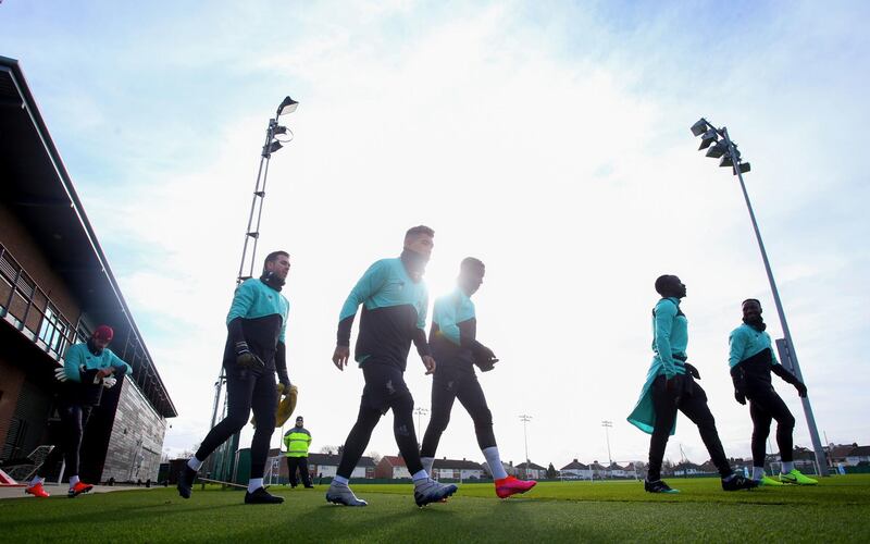 Liverpool players head onto the pitch for a training session at Melwood training ground. PA