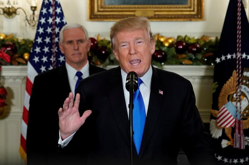 U.S. President Donald Trump, flanked by ‪Vice President Mike Pence‬, delivers remarks recognizing Jerusalem as the capital of Israel at the White House in Washington, U.S. December 6, 2017.  REUTERS/Jonathan Ernst