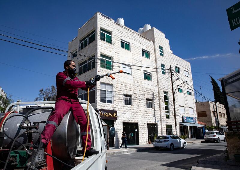 epa08397683 A Jordanian worker of Amman City hall disinfects a street of al-Weibdeh area in Amman, Jordan, 02 May 2020. After some seven weeks of lockdown, then full curfews on weekends, hairdressers, textile, shoes and some other businesses of Jordan were allowed on the last week of April to reopen their shops, and work under the conditions of wearing protective masks and applying safe distance rules. According to the Jordanian Health Ministry, the country has seen zero new cases for the past four days, the only two to  three cases registered daily in this period were at the border crossing, as truck drivers tested positive and were taken into quarantine and treatment.  EPA/ANDRE PAIN