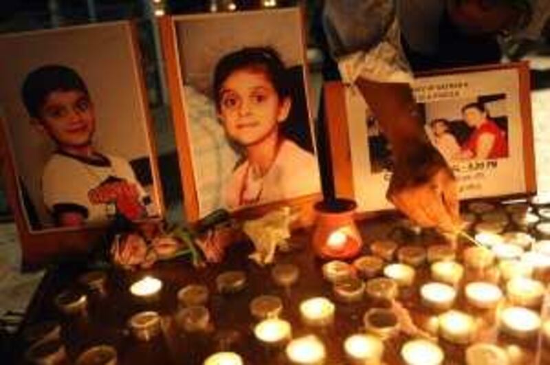 DUBAI. 28th June. 2009. Photographs of Nathan and Chelsea D'Souza the two children who died of suspected food poisoning  placed on a table for a candle - lighting vigil at St.Mary's Catholic Church in Dubai last night(sun) .  Stephen Lock  /  The National . 