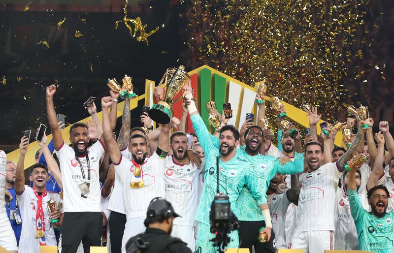 Sharjah celebrate with the trophy after winning the President's Cup final. EPA