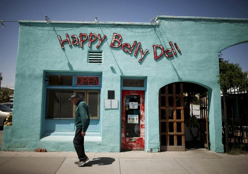 A man walks past the Happy Belly Deli in Truth or Consequences, New Mexico. Many agree that Spaceport America should inject new energy into the town. Lucy Nicholson / Reuters