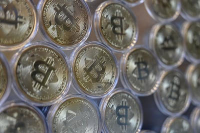 This photograph taken on December 17, 2020 shows shows a physical imitation of a Bitcoin at a crypto currency "Bitcoin Change" shop, near Grand Bazaar, in Istanbul. Leading virtual currency bitcoin on 16 December traded above $20,000 for the first time following a sustained run higher in recent weeks. Bitcoin reached a record-high $20,398.50 before pulling back to $20,145, which was still an intra-day gain of nearly four percent. / AFP / Ozan KOSE
