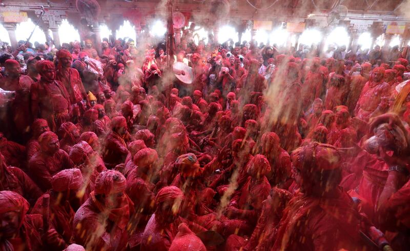 Hindu men from the villages of Nandgaon and Barsana celebrate  at the Radha Rani temple in Barsana village, Mathura, India.  EPA