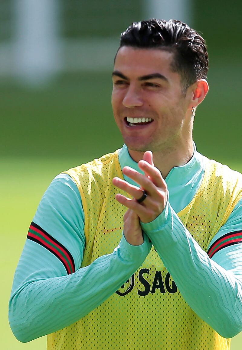 Cristiano Ronaldo laughs at Portugal training. EPA