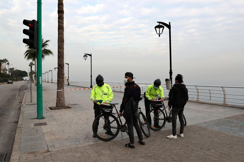 Police issue fines to civilians violating health safety measures on the waterfront in Beirut as Lebanon imposes three-week lockdown amid a record post-holiday surge of new coronavirus cases that has overwhelmed the national health sector. AP Photo