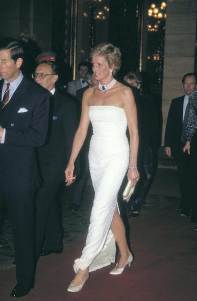 Prince Charles and Diana, Princess of Wales  (1961 - 1997) attend a dinner held by Hungarian President Arpad Goncz at the parliament buildings in Budapest, Hungary, May 1990. Diana is wearing a white beaded strapless evening gown by Catherine Walker and a pearl and sapphire choker.  (Photo by Jayne Fincher/Princess Diana Archive/Getty Images)