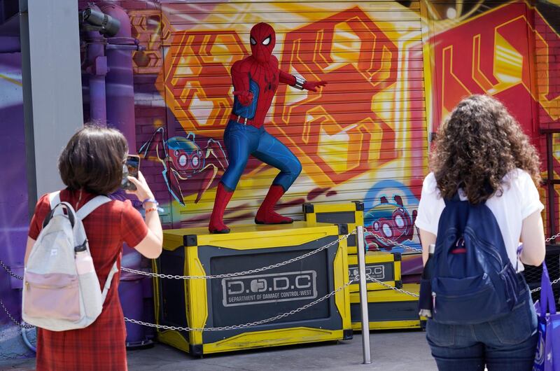 A Spider-Man character poses for guests following 'The Amazing Spider-Man!' show at the Avengers Campus. AP