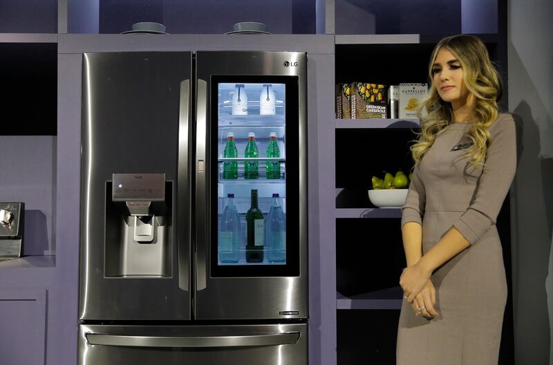 A model stands by an LG InstaView ThinQ refrigerator during a LG news conference before the CES tech show, Monday, Jan. 6, 2020, in Las Vegas. (AP Photo/John Locher)