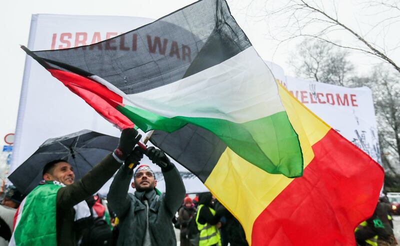 epa06382622 People hold the Belgium and Palestinian flags as they gather to protest the arrival of Israeli Prime Minister Benyamin Netanyahu on Belgian and European soil, at the European District in Brussels, Belgium, 11 December 2017. Netanyahu arrives in Brussel during the EU-Israel foreign affair meeting where he seeks the EU Jerusalem recognition, after US President Donald J. Trump recognized Jerusalem as a capital of Israel.  EPA/STEPHANIE LECOCQ