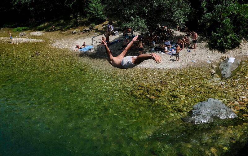 Diving into the Treska river near Skopje, as temperatures in North Macedonia soared. AFP