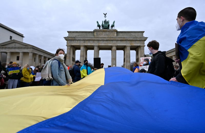 Demonstrators with Ukrainian flags in front of the Brandenburg Gate in Berlin. AFP