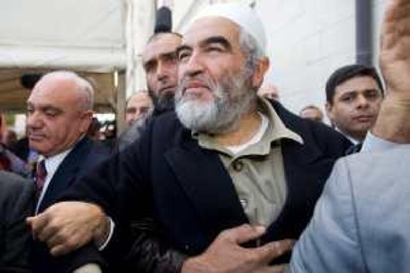 Sheik Raed Salah, the leader of the northern branch of the Islamic Movement in Israel, center, leaves the courthouse after receiving his sentence, in Jerusalem, Wednesday, Jan. 13, 2009. Jerusalem's Magistrates Court has sentenced Salah to jail for inciting a riot and assaulting a police officer. The court sentenced Salah on Wednesday for his part in a violent Jerusalem demonstration in 2007. (AP Photo/Tara Todras-Whitehill)