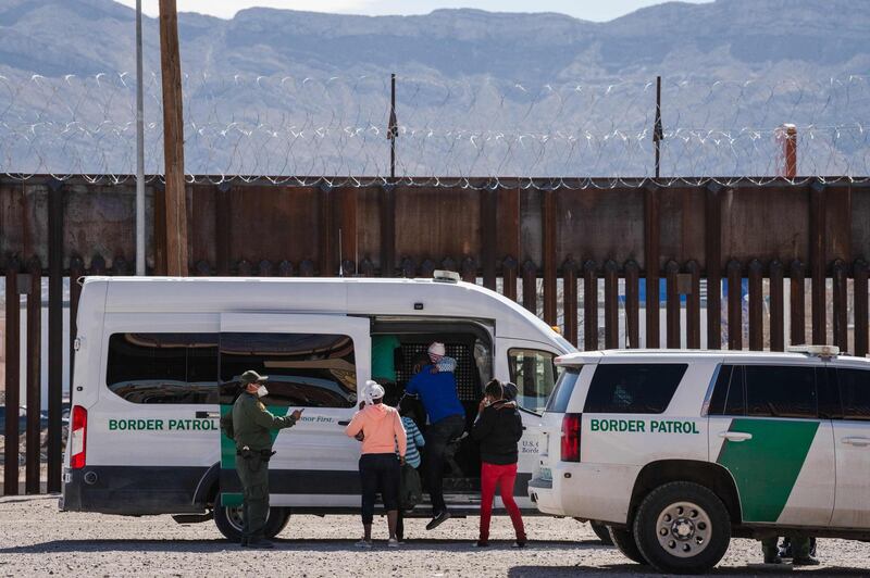 Border Patrol agents apprehend a group of migrants near downtown El Paso, Texas following the congressional border delegation visit on March 15, 2021. President Joe Biden faced mounting pressure Monday from Republicans over his handling of a surge in migrants -- including thousands of unaccompanied children -- arriving at the US-Mexican border. Republican Congressman Kevin McCarthy of California, who leads his party in the House of Representatives, told reporters last week the "crisis at the border is spiraling out of control.""It's entirely caused by the actions of this administration," said McCarthy.
 / AFP / Justin Hamel
