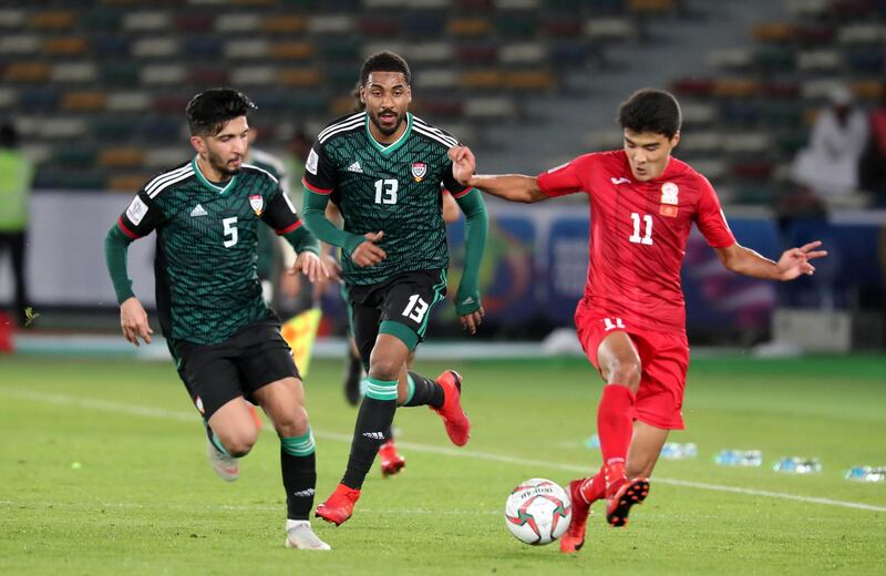 ABU DHABI , UNITED ARAB EMIRATES , January 21 ��� 2019 :- Khamis Esmaeel Zayed ( no 13 in green UAE ) and Sagynbaev Bekzhan ( no 11 in red of Kyrgyz Republic ) in action during the AFC Asian Cup UAE 2019 football match between UNITED ARAB EMIRATES vs. KYRGYZ REPUBLIC held at Zayed Sports City in Abu Dhabi. ( Pawan Singh / The National ) For News/Sports