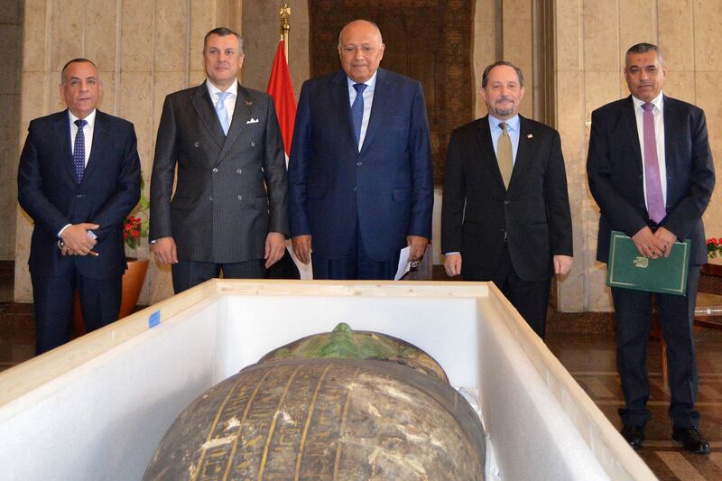 From left: Mostafa Waziri, head of Egypt's Supreme Council of Antiquities, Tourism and Antiquities Minister Ahmed Issa, Foreign Minister Sameh Shoukry and other officials attend the handover ceremony for an ancient  wooden sarcophagus that has been returned to Egypt.  AFP