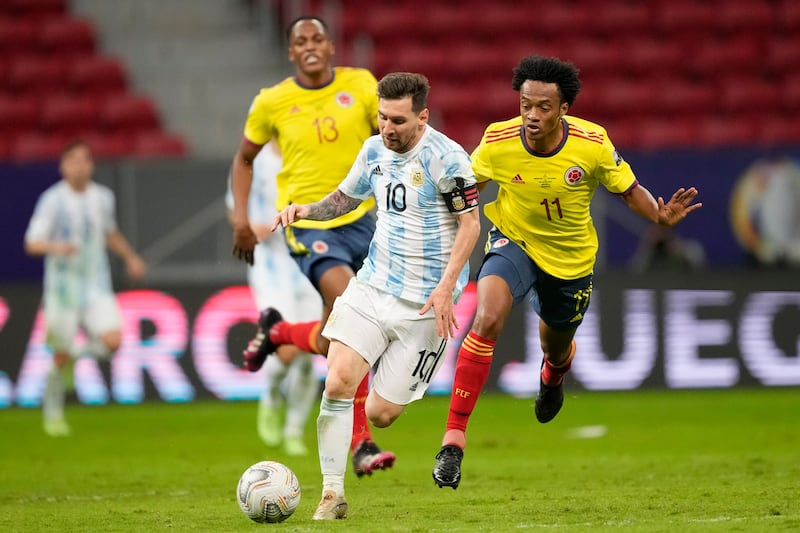 Argentina's Lionel Messi and Colombia's Juan Cuadrado battle for the ball.