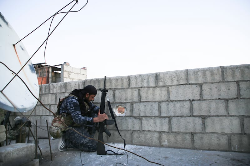 A soldier carries out safety checks. AP