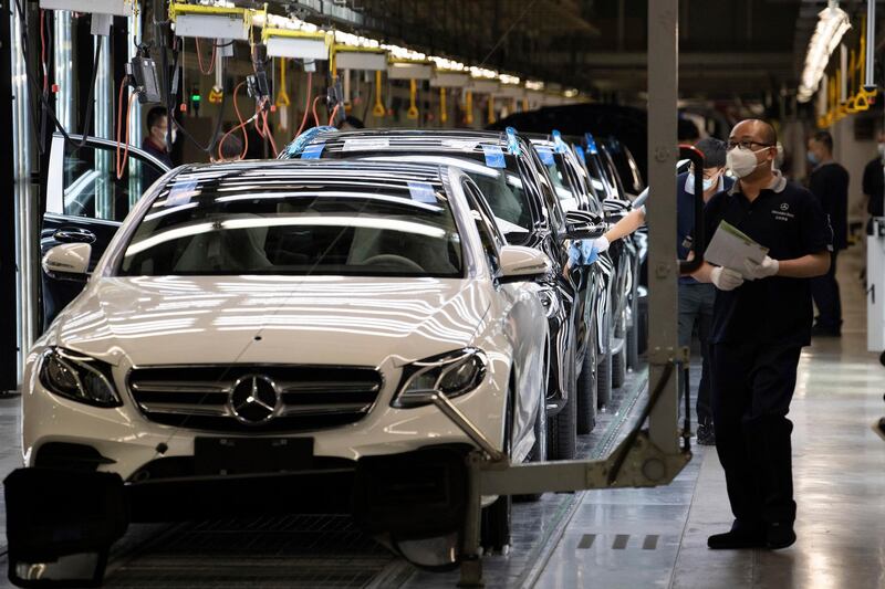 Workers inspect newly assembled cars at a Beijing Benz Automotive Co. Ltd factory, a German joint venture company for Mercedes-Benz, in Beijing on Wednesday, May 13, 2020. Chinese media reported Sunday, July 5, 2020 that Mercedes-Benz will recall more than 660,000 vehicles in China later this year for a possible oil leak with most of the vehicles being manufactured by Beijing Benz Automotive Co. (AP Photo/Ng Han Guan)
