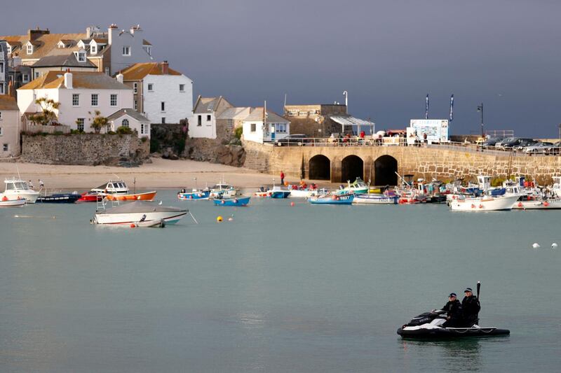 Offices from Britain's Metropolitan Police force sit on their jet ski as they patrol on the sea in St Ives, Cornwall on June 10, 2021, ahead of the three-day G7 summit being held from 11-13 June.  G7 leaders from Canada, France, Germany, Italy, Japan, the UK and the United States meet this weekend for the first time in nearly two years, for the three-day talks in Carbis Bay, Cornwall. - 
 / AFP / Adrian DENNIS
