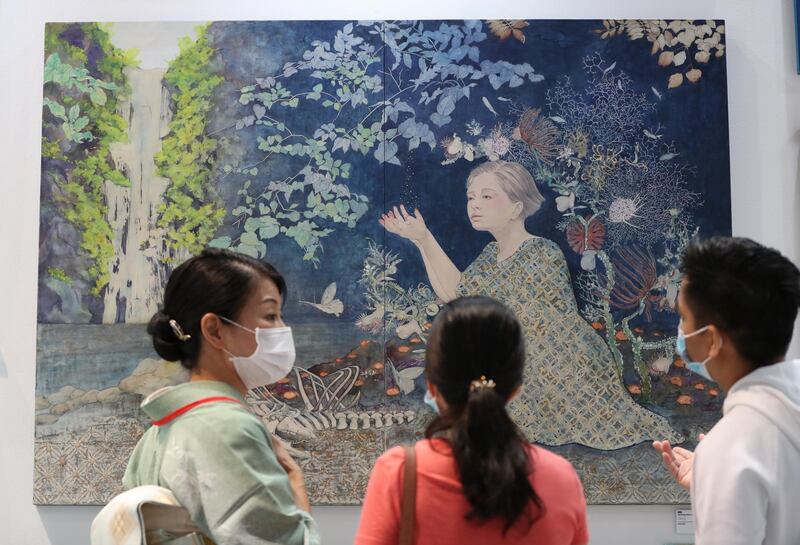 Visitors look at an artwork presented at the Japan Promotion Gallery at the World Art Dubai fair at the Dubai World Trade Centre.  EPA