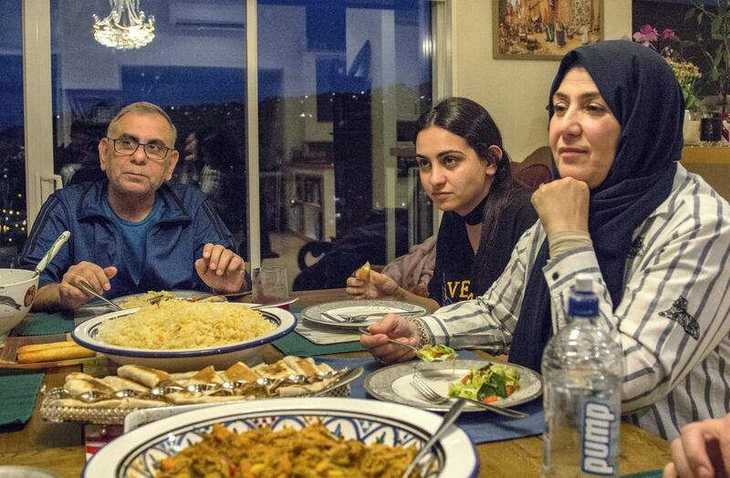 Adeeb Sami, his daughter Hamsa and his wife Sana, spending what was expected to be the last iftar of Ramadan at his home in Christchurch, New Zealand. Dave Walker/ The National. 