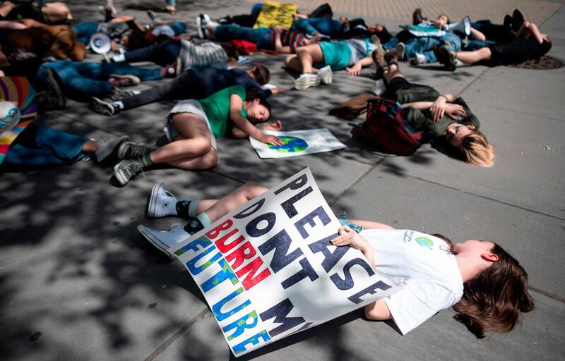 School children take part in a "Die-in" during the Youth Climate Strike outside UN headquarters. AFP