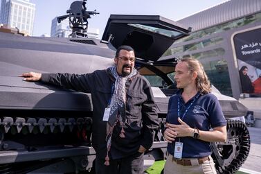 Steven Seagal and Caroline Cresp at the Streit Group stand with the Storm armoured car. Victor Besa / The National 