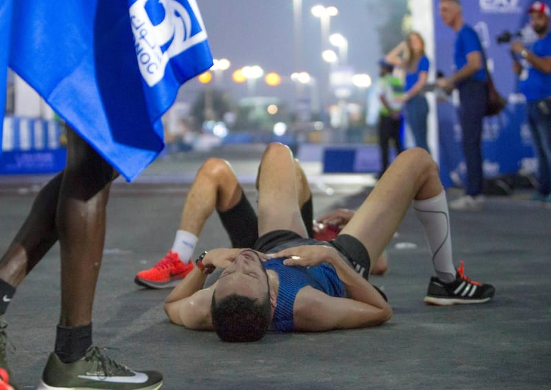 ABU DHABI, UNITED ARAB EMIRATES- 10K Marathon finishers collapsing of tiredness at the ADNOC ABU Abu Dhabi Marathon.  Leslie Pableo for The National 