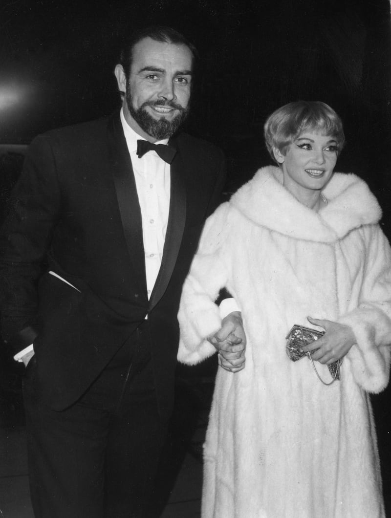 30th December 1964:  Scottish film star Sean Connery and his wife Diane Cilento arriving at the Empire Cinema in Leicester Square, London for the World Premiere of the movie 'The Yellow Rolls Royce'.  (Photo by Keystone/Getty Images)