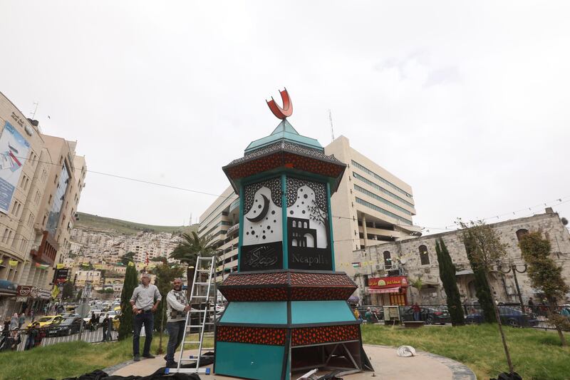 A Palestinian worker prepares a lantern on the first day of Ramadan, in the west bank city of Nablus, 24 April 2020. EPA