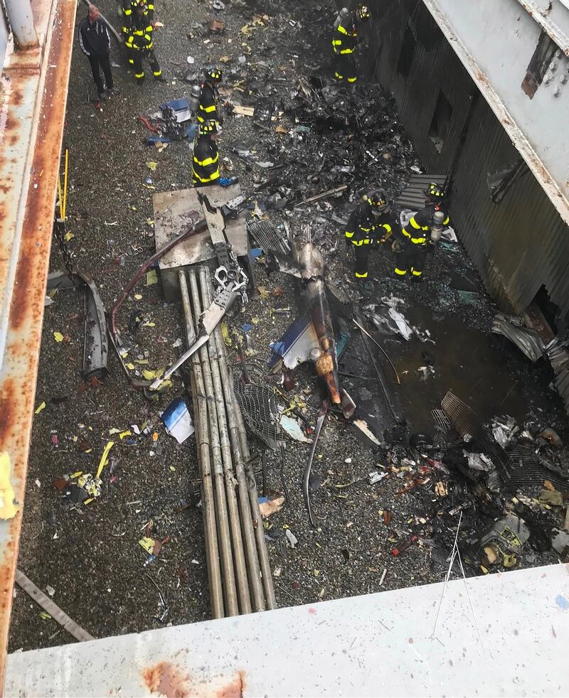 New York City firefighters working at the scene of a helicopter crash on the roof of the Equitable Building in midtown Manhattan. EPA