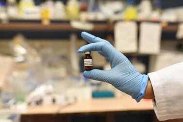 Dr Shiran Shapira, who runs the laboratory where the drug was developed, holds an empty vial which contained the new medicine. Rosie Scammell for The National