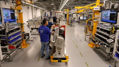 Employees work at a fuel-cell power module station inside the production line at Bosch in Stuttgart, Germany. EPA