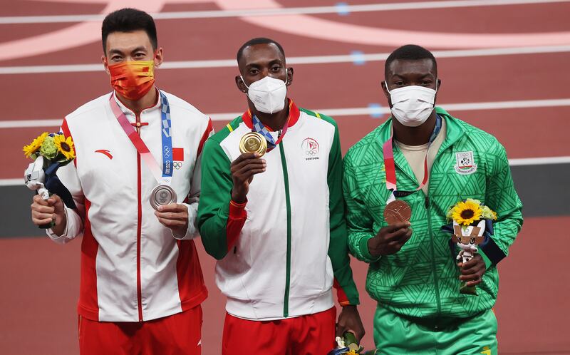 Gold medalist Pedro Pichardo (C) of Portugal, silver medalist Zhu Yaming (L) of China and bronze medalist Hugues Fabrice Zango of Burkina Faso during the medal ceremony.