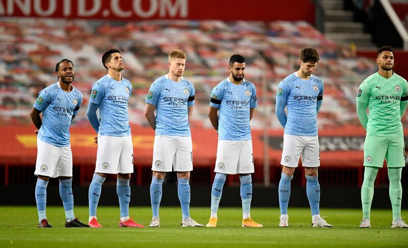Manchester City players observe a minute of silence prior to kick off in memory of  Colin Bell. Getty