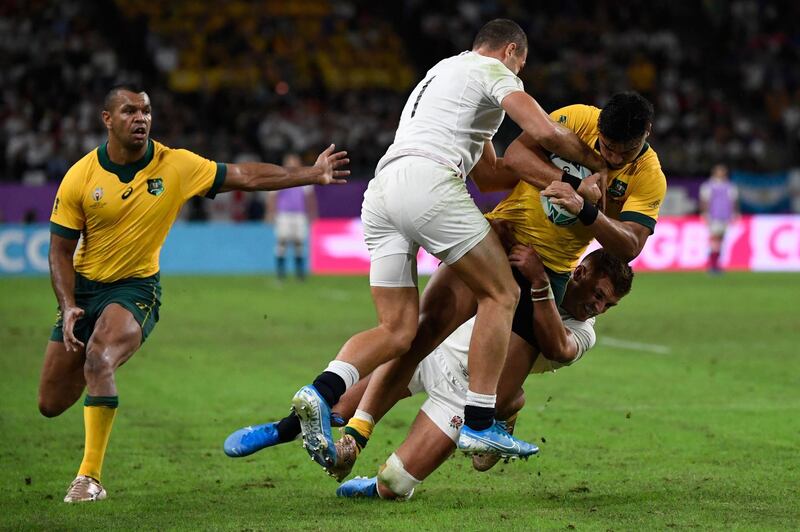 Australia's centre Jordan Petaia (R) is tackled by England's wing Jonny May (2nd L) during the Japan 2019 Rugby World Cup quarter-final match between England and Australia at the Oita Stadium in Oita. AFP