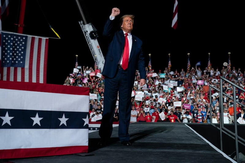 President Donald Trump pumps his fist as he walks off after speaking at a campaign rally at Orlando Sanford International Airport, in Sanford, Fla. AP Photo