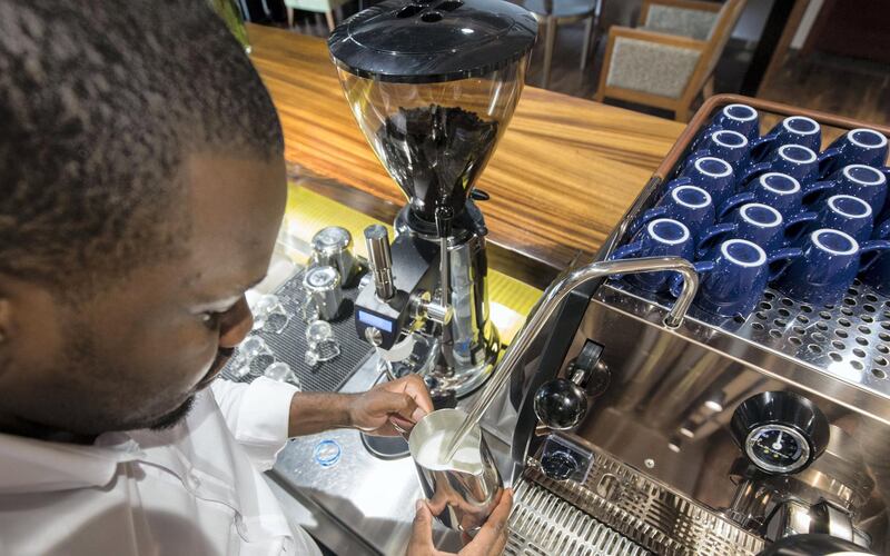 Mako Nyakotyo heats milk for a serving of speciality coffee at the DMCC Coffee Centre in Jebel Ali. Along with trading, the centre trains people to work in the coffee industry. All photos by Ruel Pableo for The National