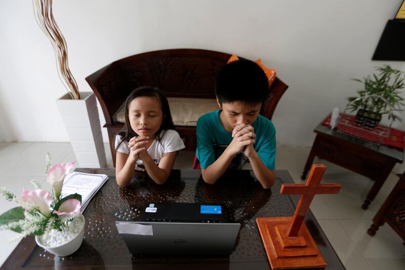Sunday school children from Batak Christian Protestant Church attend an online service to mark Good Friday from home amid the coronavirus pandemic in Banda Aceh, Indonesia. EPA