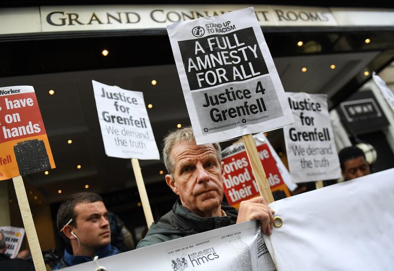 epa06203751 Protesters demonstrate outside the Grenfell Inquiry in London, Britain, 14 September 2017.  Retired High Court judge Sir Martin Moore-Bick is set to open the public inquiry into the causes of the Grenfell Tower fire. It is believed that around 80 people died in the fire in west London in June 2017.  EPA/ANDY RAIN