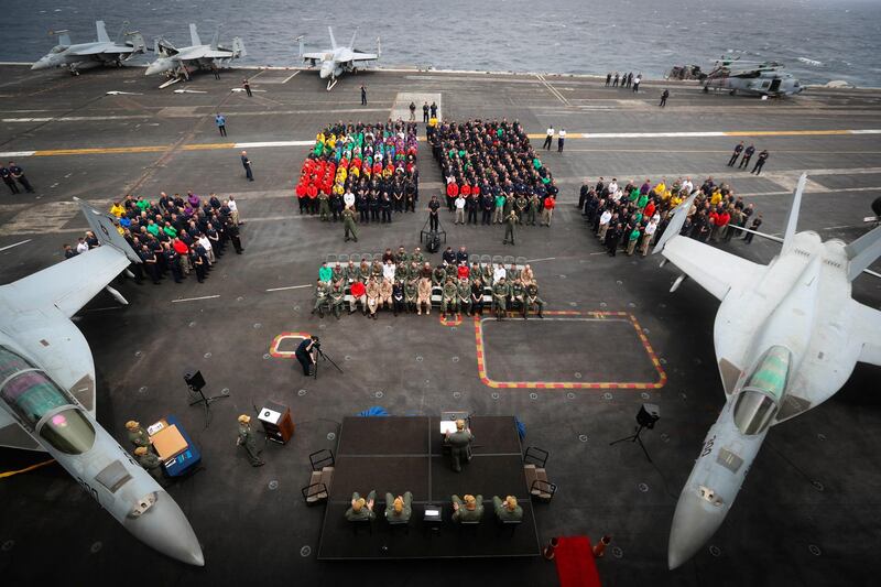 epa07748603 A handout photo made available by the US Navy shows Capt. Putnam H. Browne, commanding officer of the Nimitz-class aircraft carrier USS Abraham Lincoln (CVN 72), speaking during a change of command ceremony on the flight deck, in the Arabian Sea, 29 July 2019 (issued 30 July 2019). Capt. Walter M. Slaughter relieved Browne as Abraham Lincoln's commanding officer.  EPA/US NAVY/MC2 JESSICA PAULAUSKAS HANDOUT  HANDOUT EDITORIAL USE ONLY/NO SALES