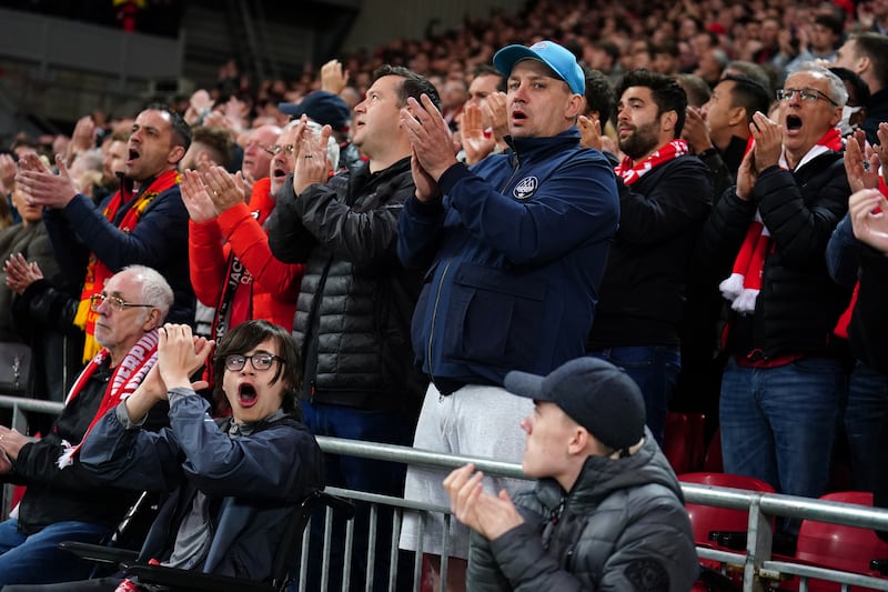 Liverpool fans applaud in the seventh minute in support for Manchester United's Cristiano Ronaldo and his family. AP