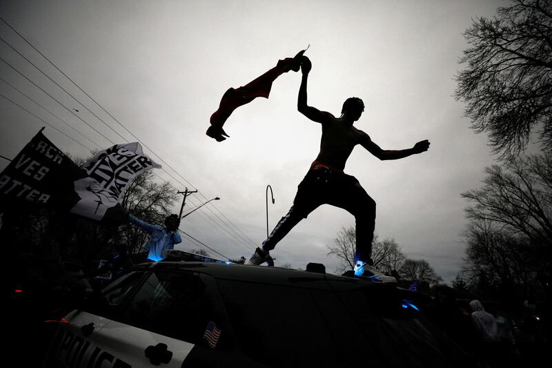 A demonstrator jumps off a police vehicle during a protest after police allegedly shot and killed a man, who local media identified as Daunte Wright, in Brooklyn Centre, Minnesota, US. Reuters