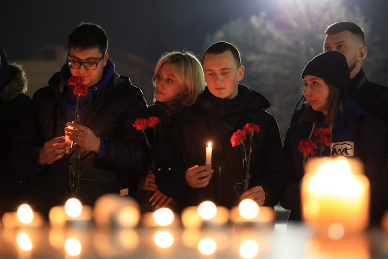 People attend a vigil in honour of the Moscow concert gun attack victims in the centre of Simferopol, Crimea. AFP