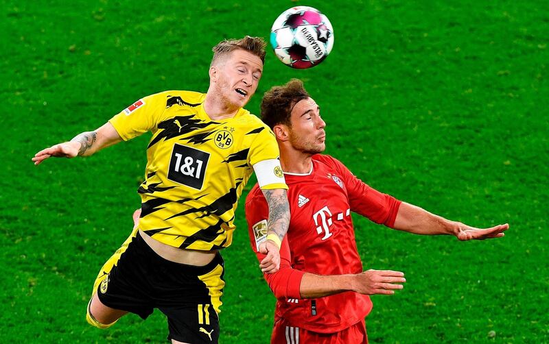 Dortmund's German forward Marco Reus and Bayern midfielder Leon Goretzka challenge for a header. AFP