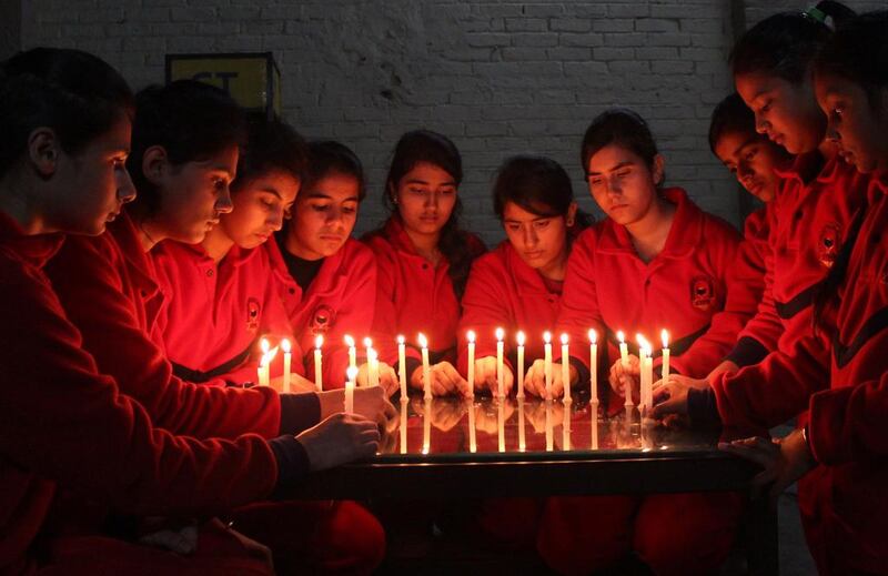 Indian schoolchildren prepare lit candles ahead of a vigil in Jalandhar, India as they pay tribute to the 132 slain Pakistani schoolchildren and nine staff. Taliban insurgents stormed an army-run school in the northwestern city of Peshawar and systematically went from room to room shooting children during an eight-hour killing spree. Shammi Mehra / AFP