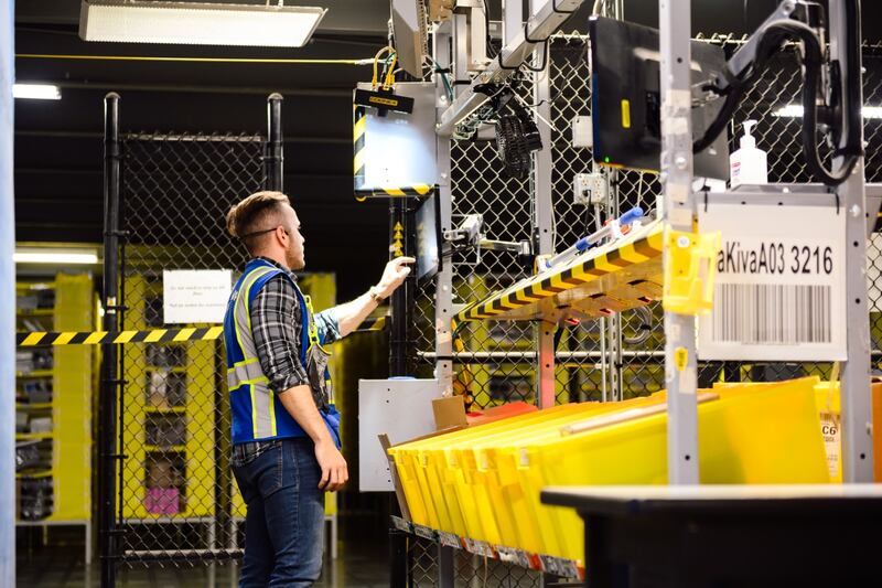 A worker inputs data while preparing orders for shipment at an Amazon fulfillment centre in Kent, Washington. Bloomberg
